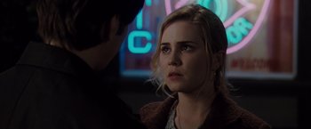 Movie still from “Drag Me to Hell” (2009), directed by Sam Raimi – A young woman looking at the camera while a man looks at her; Close Up shot, Over the shoulder angle