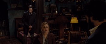 Movie still from “Drag Me to Hell” (2009), directed by Sam Raimi – A woman and a man are in a room; Medium shot, High angle