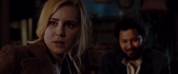 Movie still from “Drag Me to Hell” (2009), directed by Sam Raimi – A person in a room near a person; Close Up shot, Over the shoulder angle