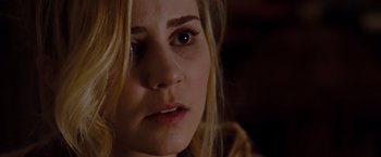 Movie still from “Drag Me to Hell” (2009), directed by Sam Raimi – A woman's face in a dark room; Close Up shot, Over the shoulder angle