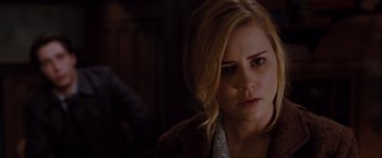 Movie still from “Drag Me to Hell” (2009), directed by Sam Raimi – A woman with blonde hair is looking at the camera; Close Up shot, Over the shoulder angle