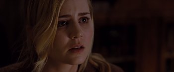 Movie still from “Drag Me to Hell” (2009), directed by Sam Raimi – A person looking at the camera; Close Up shot, Over the shoulder angle