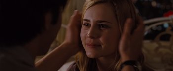 Movie still from “Drag Me to Hell” (2009), directed by Sam Raimi – A young woman is putting on a pair of earrings; Close Up shot, Over the shoulder angle