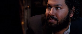 A person wearing a suit and beard