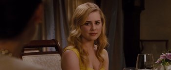 Movie still from “Drag Me to Hell” (2009), directed by Sam Raimi – A beautiful young lady in a yellow dress; Close Up shot, Over the shoulder angle