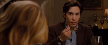 Movie still from “Drag Me to Hell” (2009), directed by Sam Raimi – A man in a brown jacket is eating cereal from a spoon; Close Up shot, Over the shoulder angle