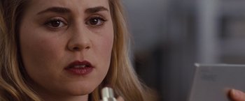 Movie still from “Drag Me to Hell” (2009), directed by Sam Raimi – A person holding a cell phone; Close Up shot, Over the shoulder angle