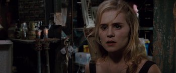 Movie still from “Drag Me to Hell” (2009), directed by Sam Raimi – A young woman with blonde long hair looking at the camera; Close Up shot, Over the shoulder angle