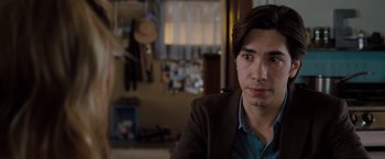 Movie still from “Drag Me to Hell” (2009), directed by Sam Raimi – A man in a suit and tie in a room; Close Up shot, Over the shoulder angle