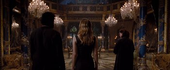 Movie still from “Drag Me to Hell” (2009), directed by Sam Raimi – A woman standing in front of two other people; Wide shot, Over the shoulder angle