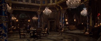 Movie still from “Drag Me to Hell” (2009), directed by Sam Raimi – People are sitting at a table in an ornate room; Wide shot, High angle