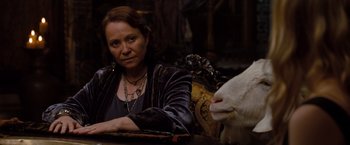 Movie still from “Drag Me to Hell” (2009), directed by Sam Raimi – A woman sitting in front of a white sheep; Medium shot, Over the shoulder angle