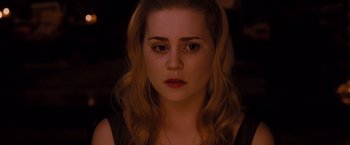 Movie still from “Drag Me to Hell” (2009), directed by Sam Raimi – A person wearing a black shirt; Close Up shot, Over the shoulder angle