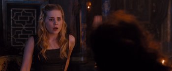 Movie still from “Drag Me to Hell” (2009), directed by Sam Raimi – A young woman in a black dress looking at the camera; Close Up shot, Over the shoulder angle