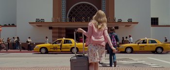 Movie still from “Drag Me to Hell” (2009), directed by Sam Raimi – A woman with a suitcase walking down a street; Wide shot, Low angle