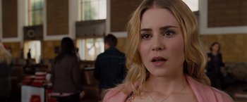 Movie still from “Drag Me to Hell” (2009), directed by Sam Raimi – A person wearing a pink shirt; Close Up shot, Over the shoulder angle