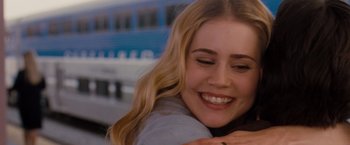Movie still from “Drag Me to Hell” (2009), directed by Sam Raimi – A person smiling and hugging; Close Up shot, Over the shoulder angle
