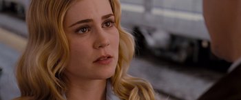 Movie still from “Drag Me to Hell” (2009), directed by Sam Raimi – A person with long blonde hair; Close Up shot, Over the shoulder angle