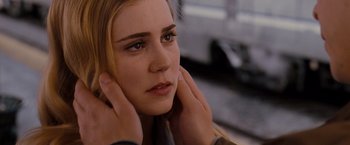 Movie still from “Drag Me to Hell” (2009), directed by Sam Raimi – A person with their hands on their head; Close Up shot, Over the shoulder angle