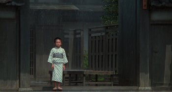 Movie still from “Dreams” (1990), directed by Akira Kurosawa – A little boy standing in front of a wooden bench; Wide shot, Low angle