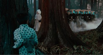 Movie still from “Dreams” (1990), directed by Akira Kurosawa – A group of people standing next to a large tree; Extreme Wide shot, High angle