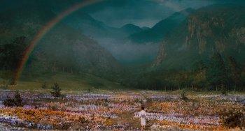Movie still from “Dreams” (1990), directed by Akira Kurosawa – A person standing in a field of flowers with a rainbow in the background; Extreme Wide shot, High angle