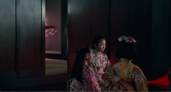 Movie still from “Dreams” (1990), directed by Akira Kurosawa – Two young girls in kimonos sitting next to each other; Medium shot, Low angle