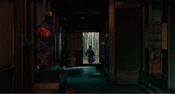 Movie still from “Dreams” (1990), directed by Akira Kurosawa – A person is standing in a doorway of a house; Extreme Wide shot, High angle