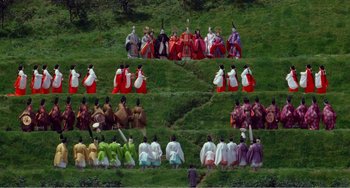 Movie still from “Dreams” (1990), directed by Akira Kurosawa – A group of people dressed in colorful costumes; Extreme Wide shot, Overhead angle