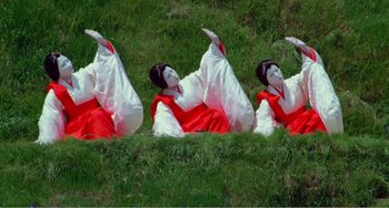 Movie still from “Dreams” (1990), directed by Akira Kurosawa – A group of people dressed as geishas in the grass; Extreme Wide shot, Low angle