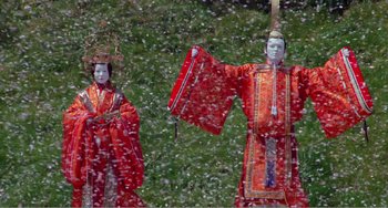 Movie still from “Dreams” (1990), directed by Akira Kurosawa – A couple of people in red costumes standing next to each other in the snow; Wide shot, Low angle