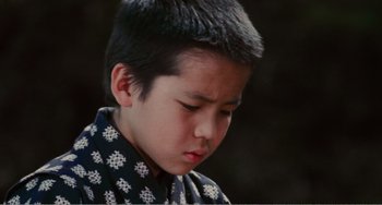 Movie still from “Dreams” (1990), directed by Akira Kurosawa – A young boy is looking down at his face; Close Up shot, High angle