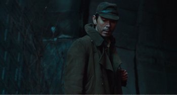 Movie still from “Dreams” (1990), directed by Akira Kurosawa – A man wearing a green coat and hat; Medium shot, Over the shoulder angle
