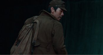 Movie still from “Dreams” (1990), directed by Akira Kurosawa – A man wearing a brown jacket and a hat; Medium shot, Low angle