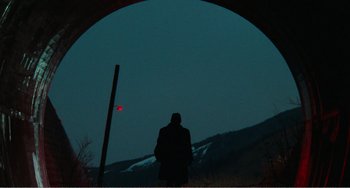 Movie still from “Dreams” (1990), directed by Akira Kurosawa – A man standing in a tunnel looking at the sky; Extreme Wide shot, Low angle
