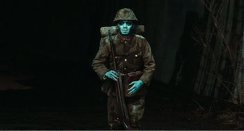 Movie still from “Dreams” (1990), directed by Akira Kurosawa – A man dressed as a soldier with a rifle in his hand; Wide shot, High angle