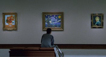 Movie still from “Dreams” (1990), directed by Akira Kurosawa – A man sitting on a bench in front of a painting; Wide shot, Low angle