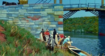 Movie still from “Dreams” (1990), directed by Akira Kurosawa – A group of people on a boat on a body of water; Extreme Wide shot, High angle