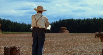 Movie still from “Dreams” (1990), directed by Akira Kurosawa – An old man in a field looking at a stack of hay; Wide shot, Low angle
