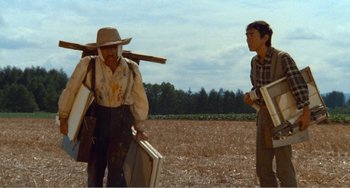 Movie still from “Dreams” (1990), directed by Akira Kurosawa – Two men standing in the middle of an open field; Medium shot, Low angle