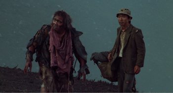 Movie still from “Dreams” (1990), directed by Akira Kurosawa – Two men are walking on a hill with bags; Medium shot, Low angle