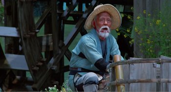 Movie still from “Dreams” (1990), directed by Akira Kurosawa – An old man sitting on top of a wooden barrel; Medium shot, Low angle