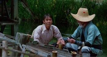 Movie still from “Dreams” (1990), directed by Akira Kurosawa – Two men sitting in a boat on a river; Medium shot, High angle