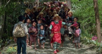 Movie still from “Dreams” (1990), directed by Akira Kurosawa – An old man in a red outfit and a crowd of people in the background; Wide shot, High angle