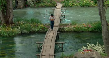 Movie still from “Dreams” (1990), directed by Akira Kurosawa – A man walking across a wooden bridge over a river; Extreme Wide shot, High angle