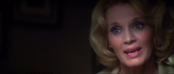 Movie still from “Dressed to Kill” (1980), directed by Brian De Palma – A woman's face with her hair blowing in the wind; Close Up shot, Over the shoulder angle