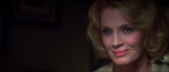 Movie still from “Dressed to Kill” (1980), directed by Brian De Palma – A woman with blonde hair and blue eyes; Close Up shot, Over the shoulder angle