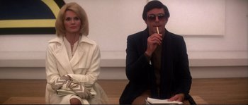 Movie still from “Dressed to Kill” (1980), directed by Brian De Palma – A man and a woman sitting next to each other; Medium shot, Low angle