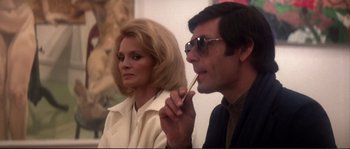 Movie still from “Dressed to Kill” (1980), directed by Brian De Palma – A man and a woman sitting next to each other; Medium shot, Low angle