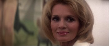 Movie still from “Dressed to Kill” (1980), directed by Brian De Palma – A woman's face in a white shirt; Close Up shot, Over the shoulder angle